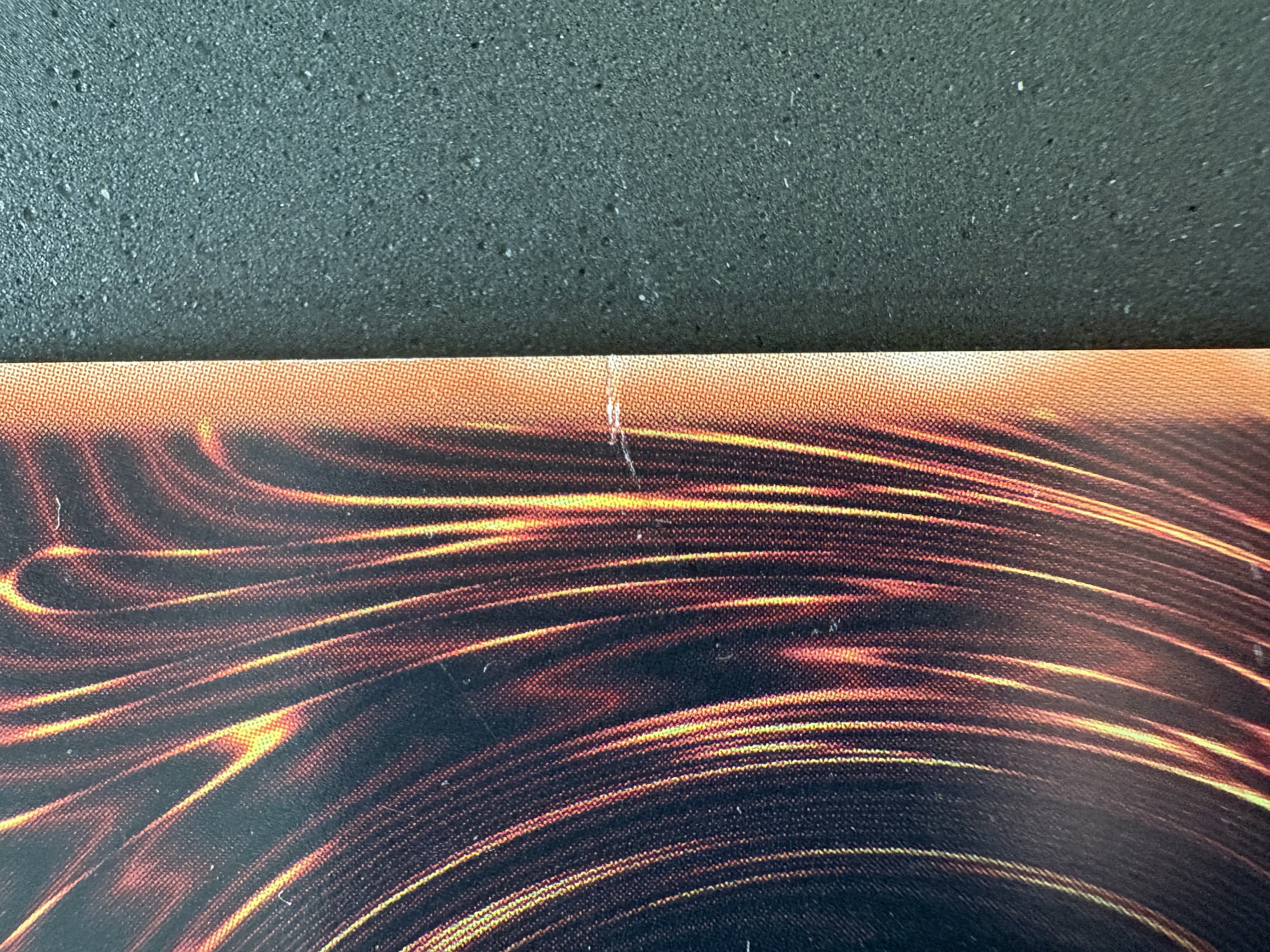 Ink damage on the right edge (where the crease is on the front left edge)