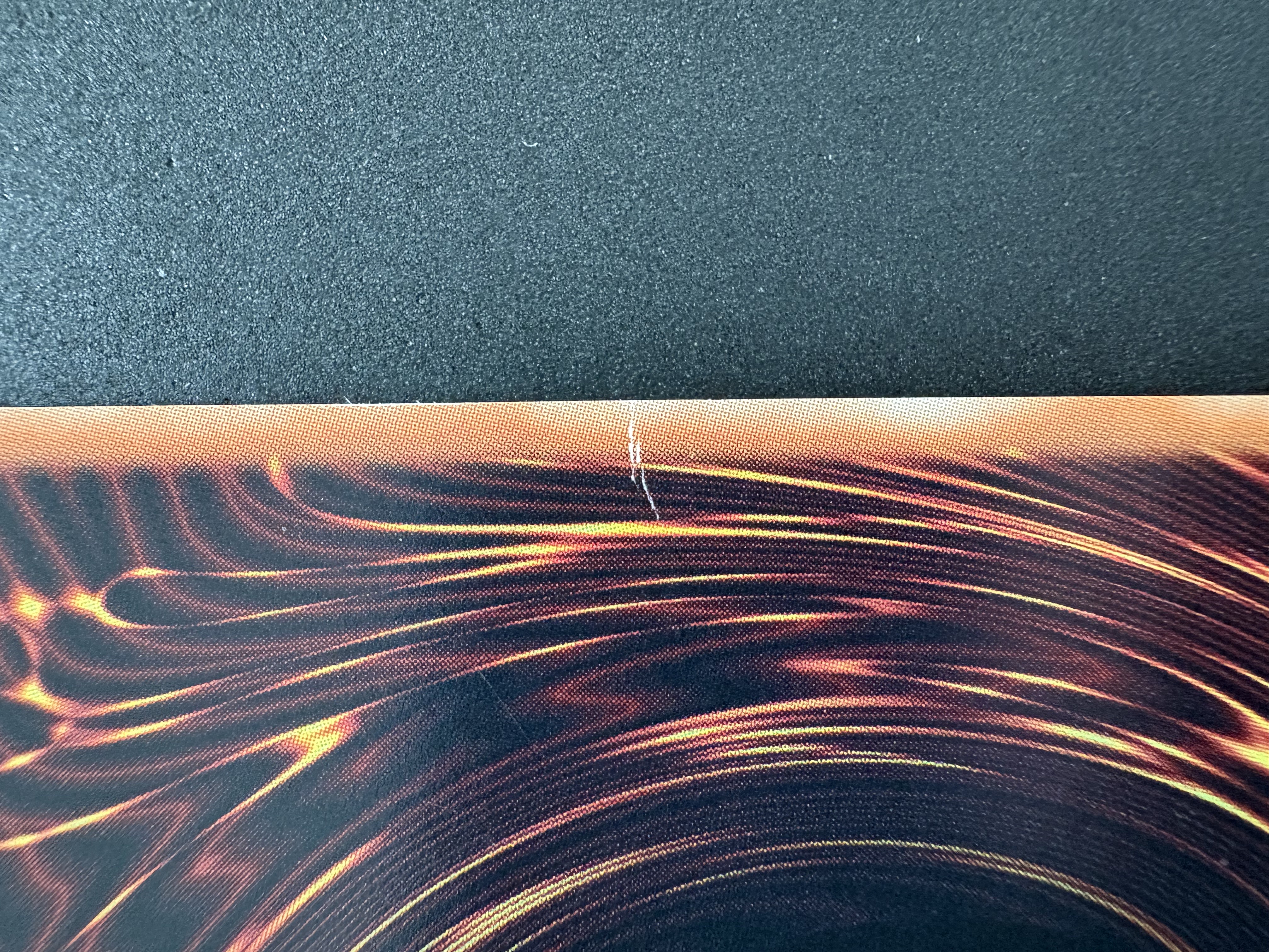 Ink damage on the right edge (where the crease is on the front left edge)